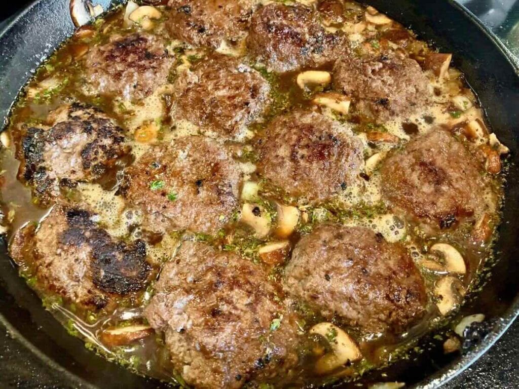 gluten-free Salisbury Steak cooking in skillet