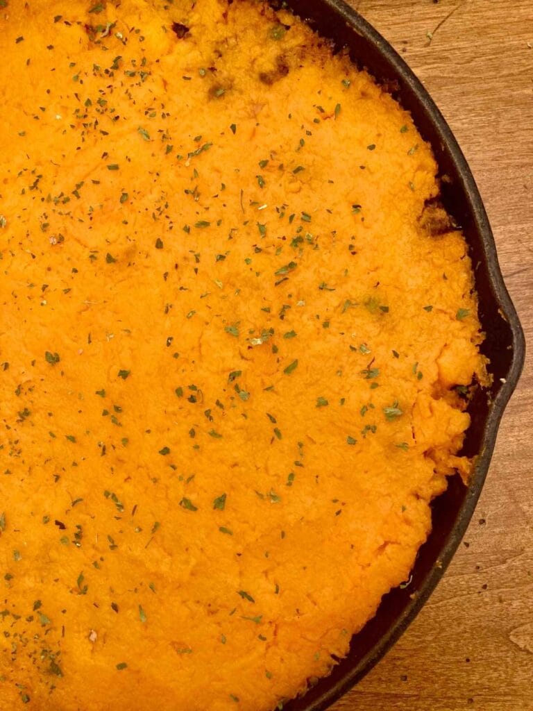 Half a skillet with sweet potato cottage pie