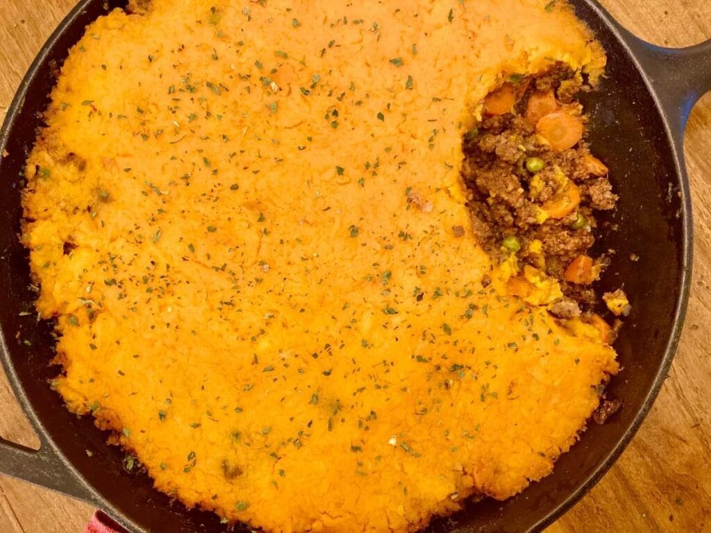 Sweet potato cottage pie with piece cut out of it