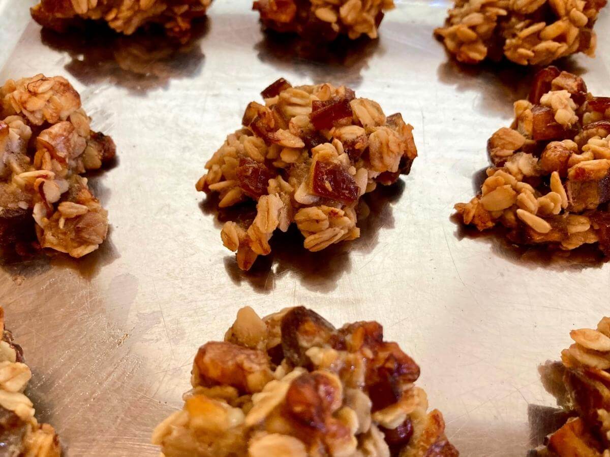 Baked banana and date oatmeal cookies on cookie sheet.