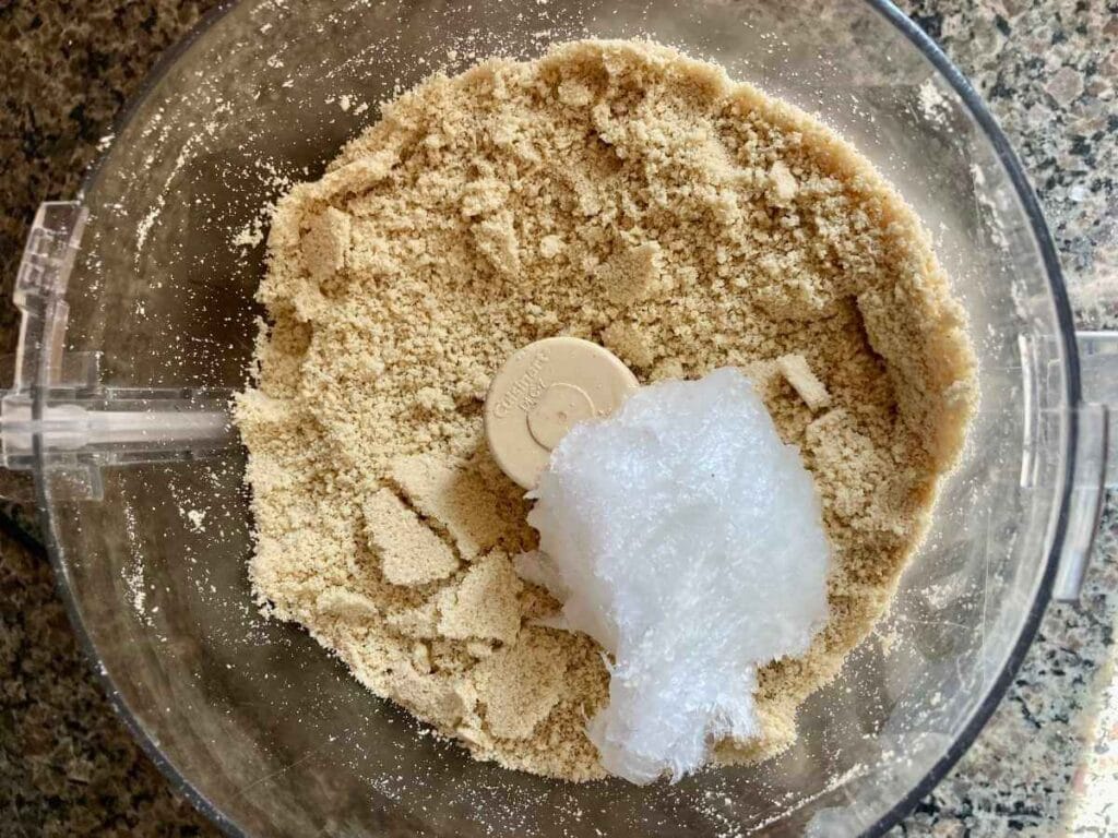 Ground cashews with coconut oil and salt in a food processor.