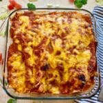 Chicken and cilantro enchiladas in a baking dish.