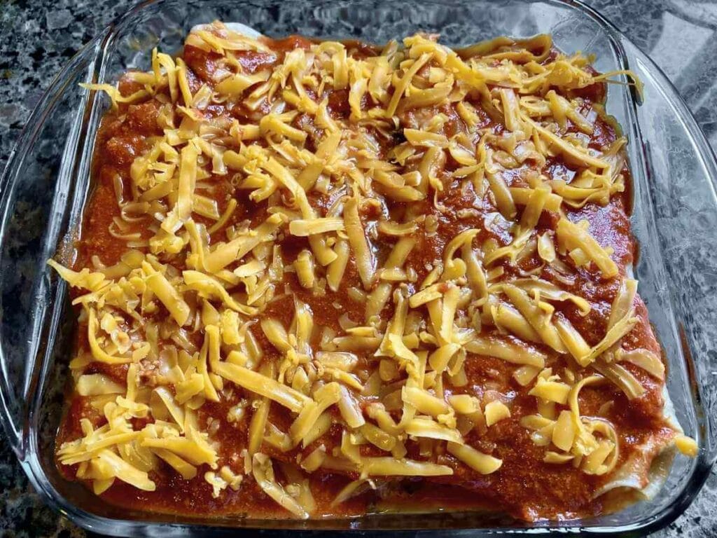 Unbaked chicken and cilantro enchiladas.