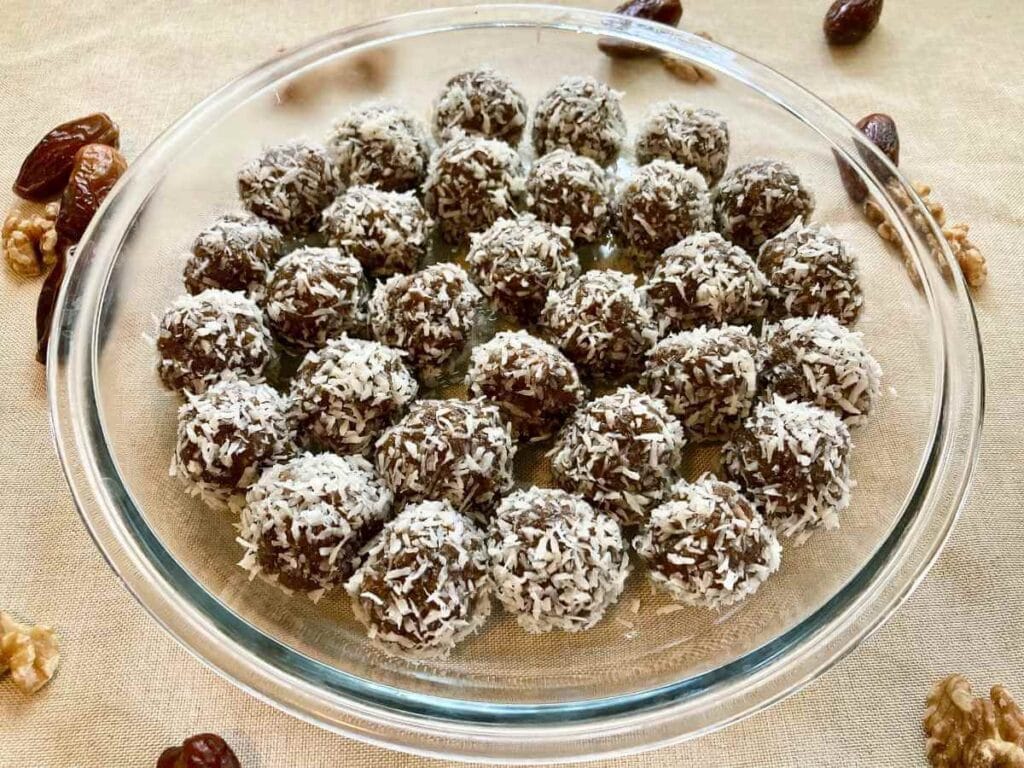 Side angle of energy balls with dates in a baking dish.