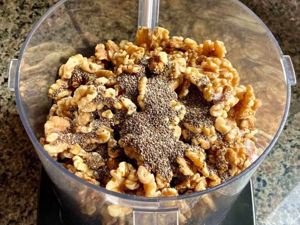 Walnuts, dates, chia seeds, salt, and vanilla in a food processor.