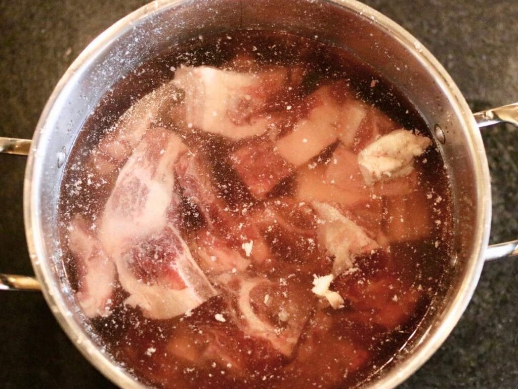 Beef bones in a pot of water.