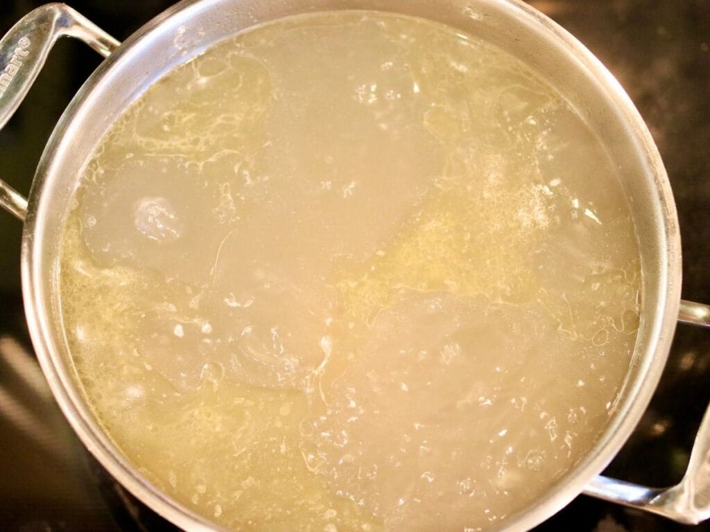 Bone broth simmering on the stove.