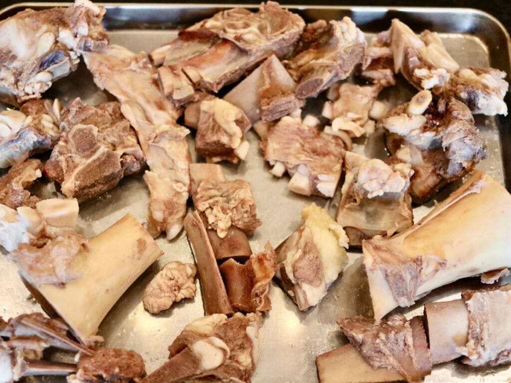 Beef bones on a baking sheet.