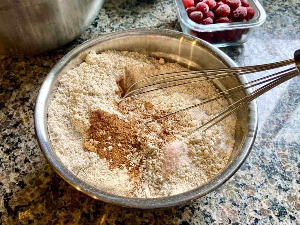 Whisking dry ingredients in a bowl.