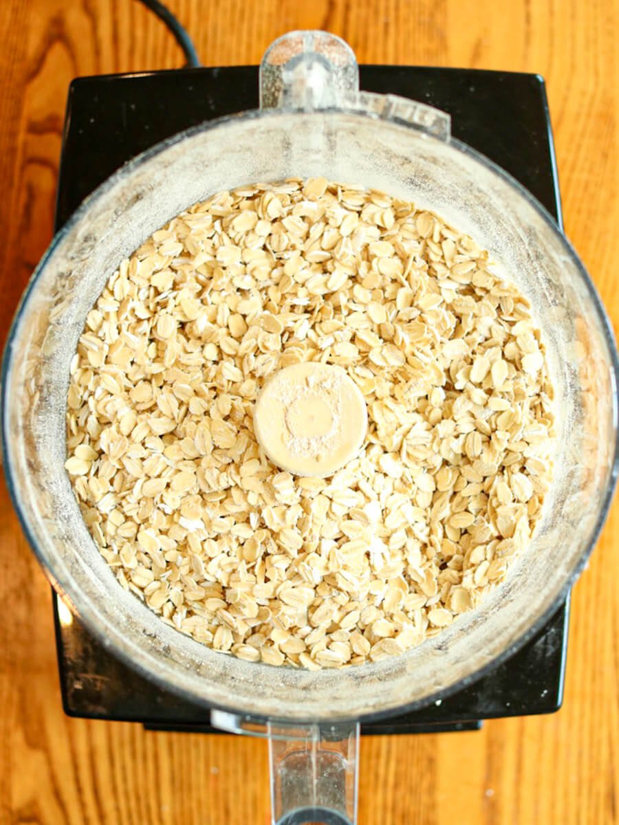 Rolled oats in a food processor ready to be ground.
