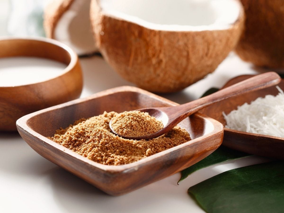 Dish of coconut sugar with a wooden spoon.