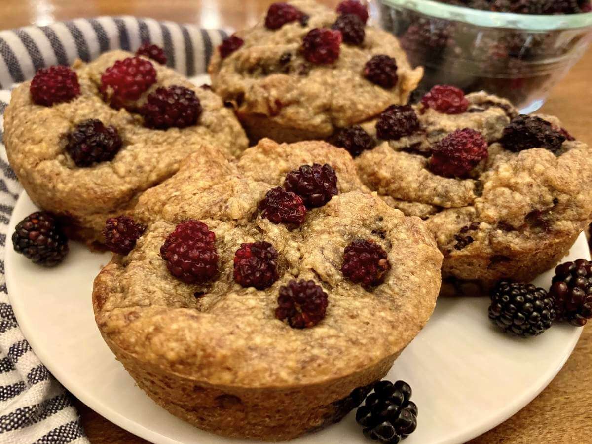 Blackberry banana breakfast muffins on a plate.