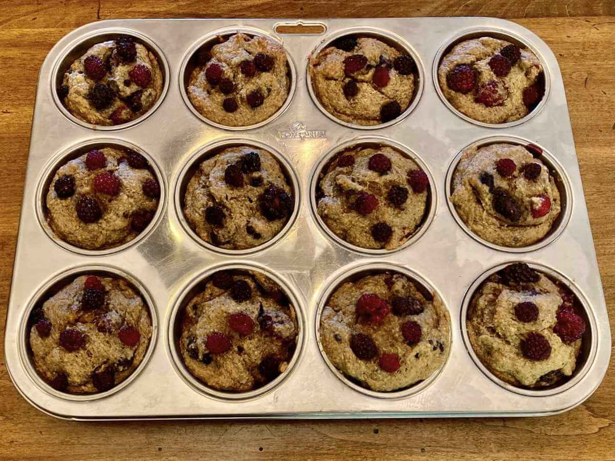 Blackberry banana breakfast muffins in a muffin pan.