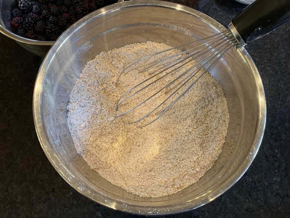 Whisking dry ingredients in a bowl.