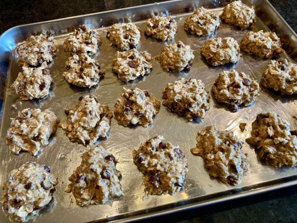 Unbaked cookies on a cookie sheet.