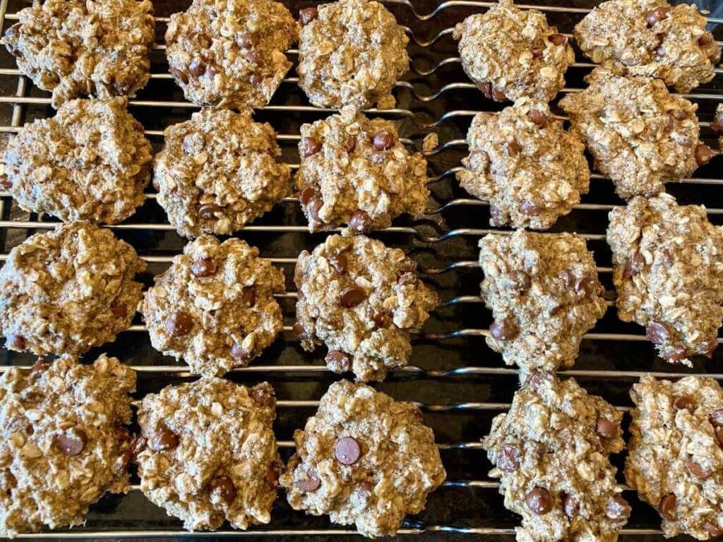 Gluten-free chocolate oatmeal cookies on a cooling rack.