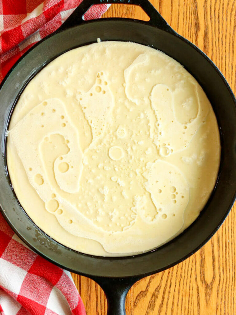 Batter in a cast iron skillet ready for baking.