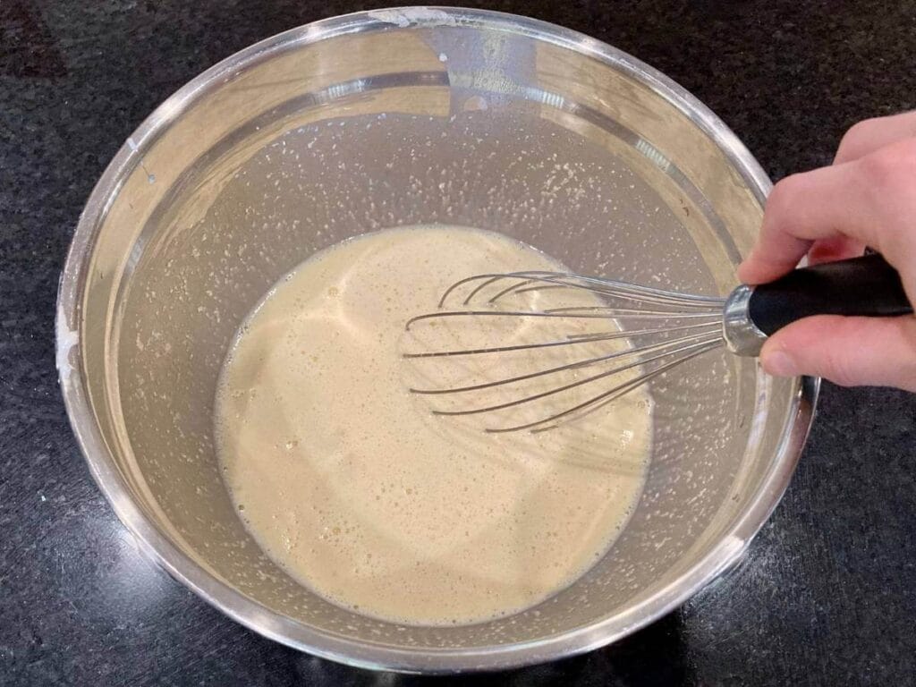 Whisking batter in a bowl.