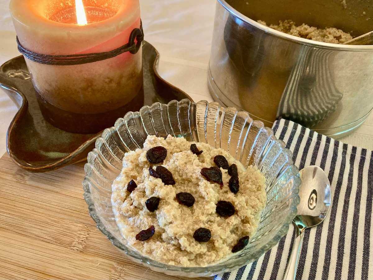 Quinoa pudding in a bowl with dried cranberries.