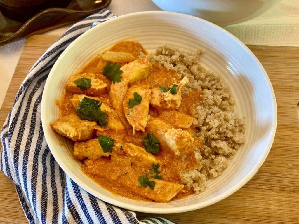 Indian chicken curry in a bowl with quinoa.