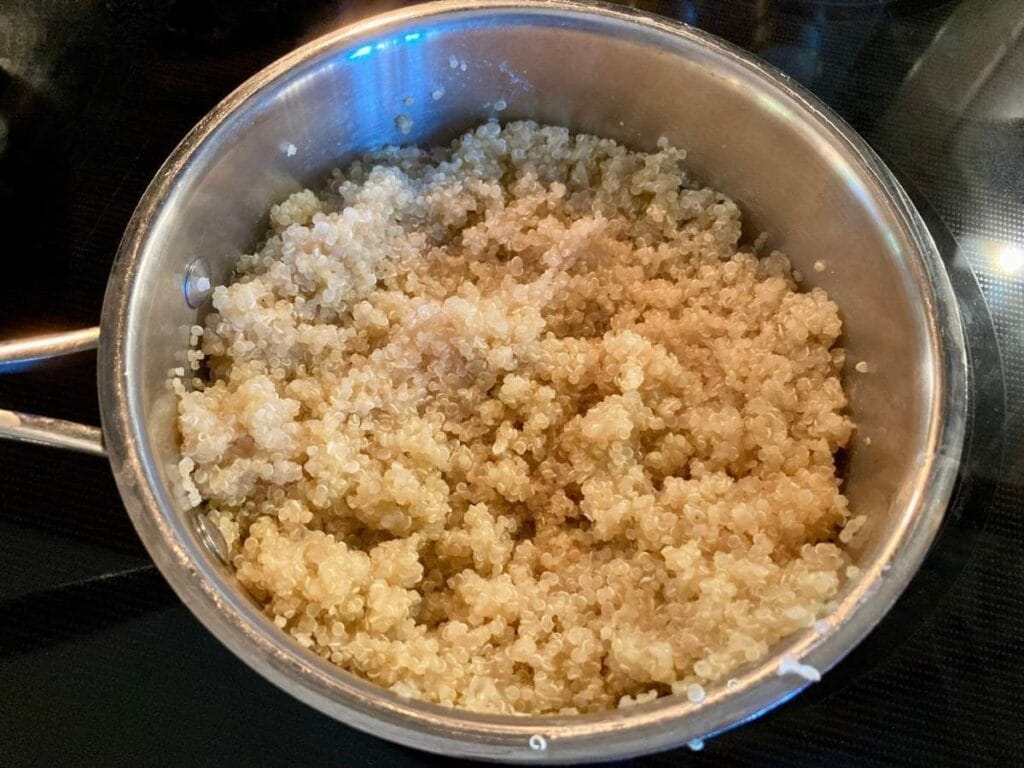 Pot of cooked quinoa on the stove.
