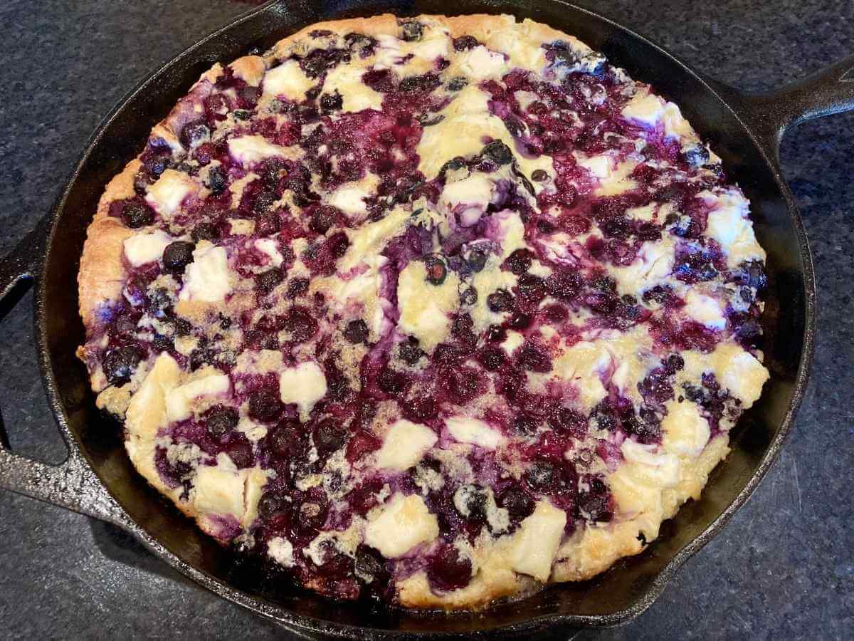 Blueberry cheesecake German pancake in a skillet fresh out of the oven.