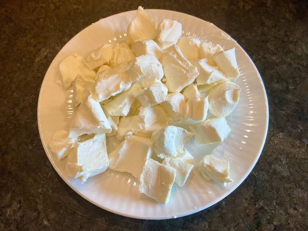 Cubed cream cheese on a plate.