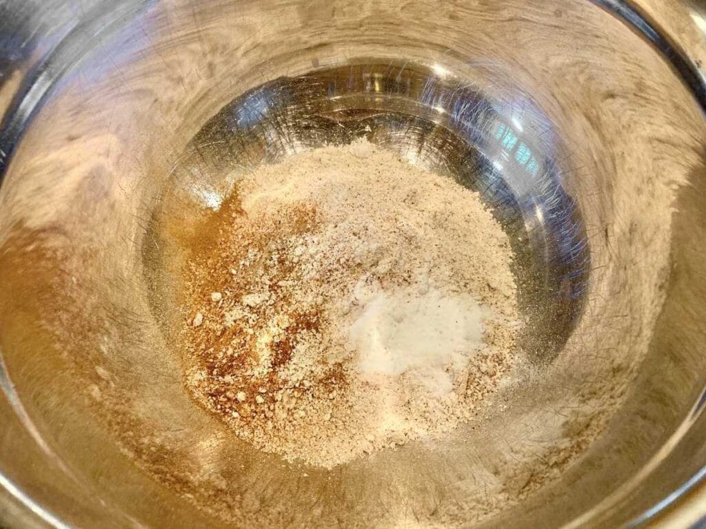 Whisking pumpkin pancake dry ingredients in a bowl.