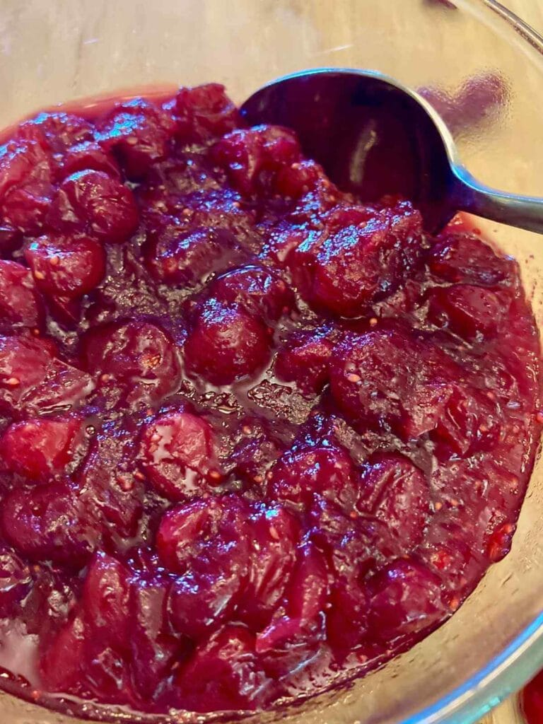 Spoon scooping refined sugar-free cranberry sauce.