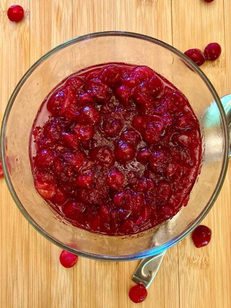 Refined sugar-free cranberry sauce in a glass serving bowl.
