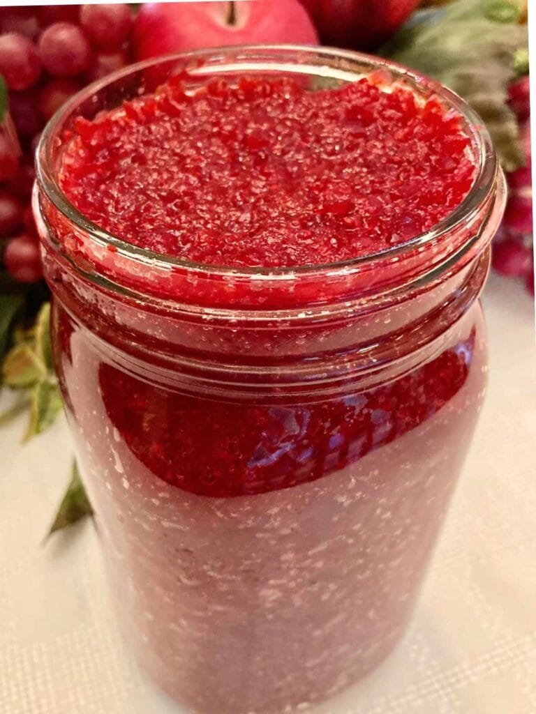 Fermented cranberries in an open jar.