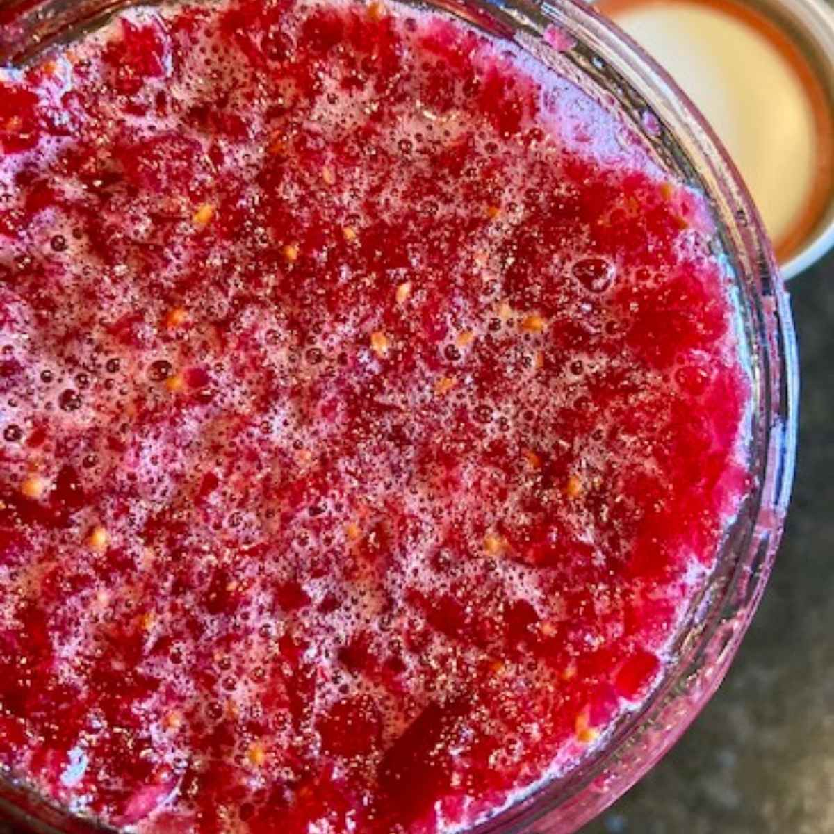 Closeup of fermented cranberries in a jar.
