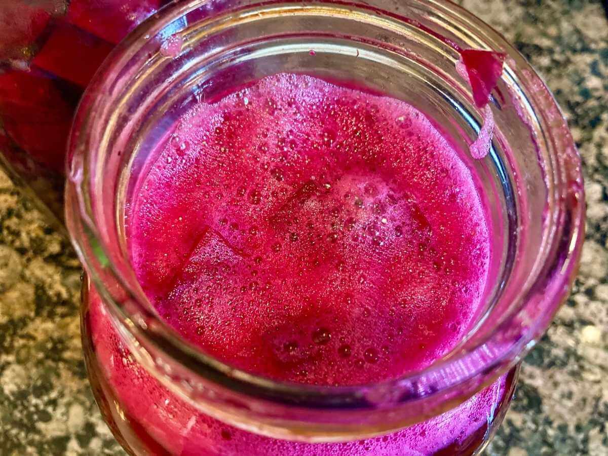 Top view of open jar of beet kvass.