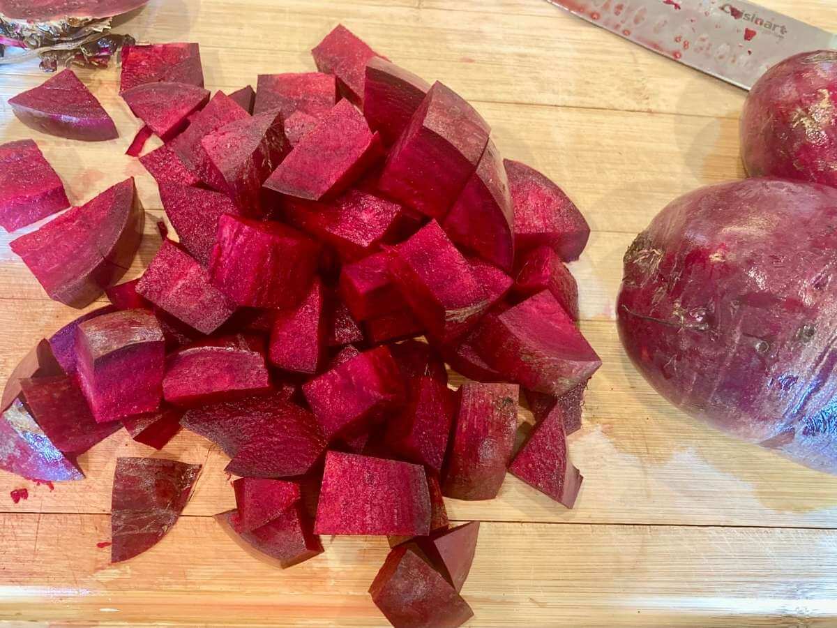 Chopping beets on a cutting board.