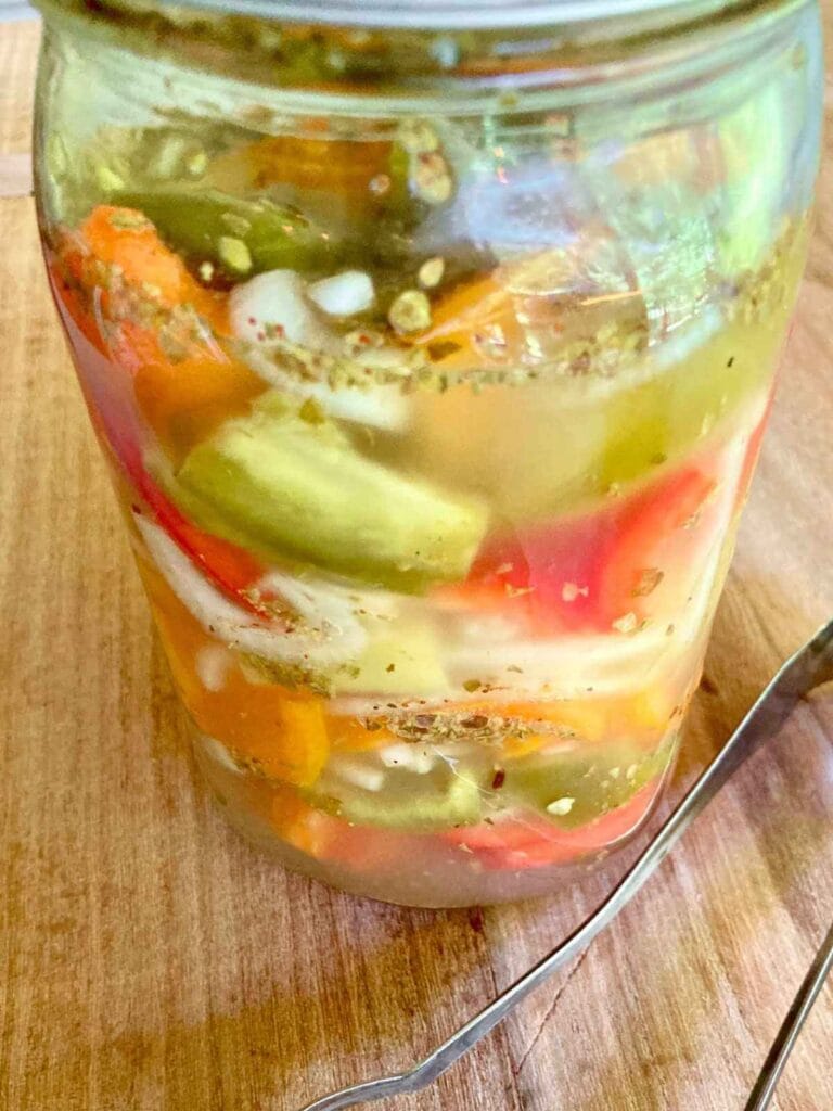 Fermented peppers and onions in a jar.