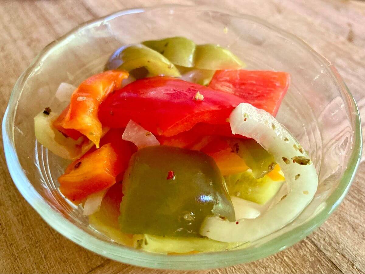 Fermented peppers and onions in a small bowl.