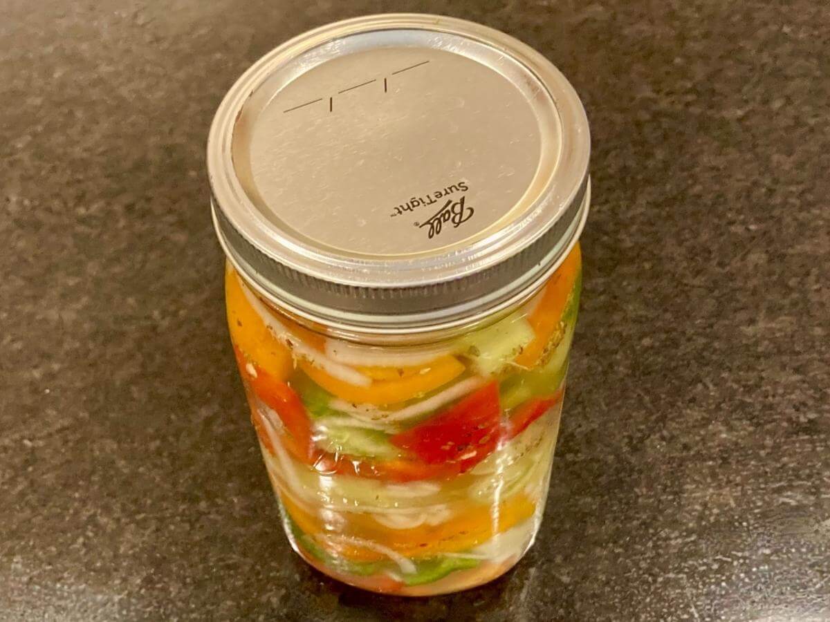 Peppers and onions in a mason jar.