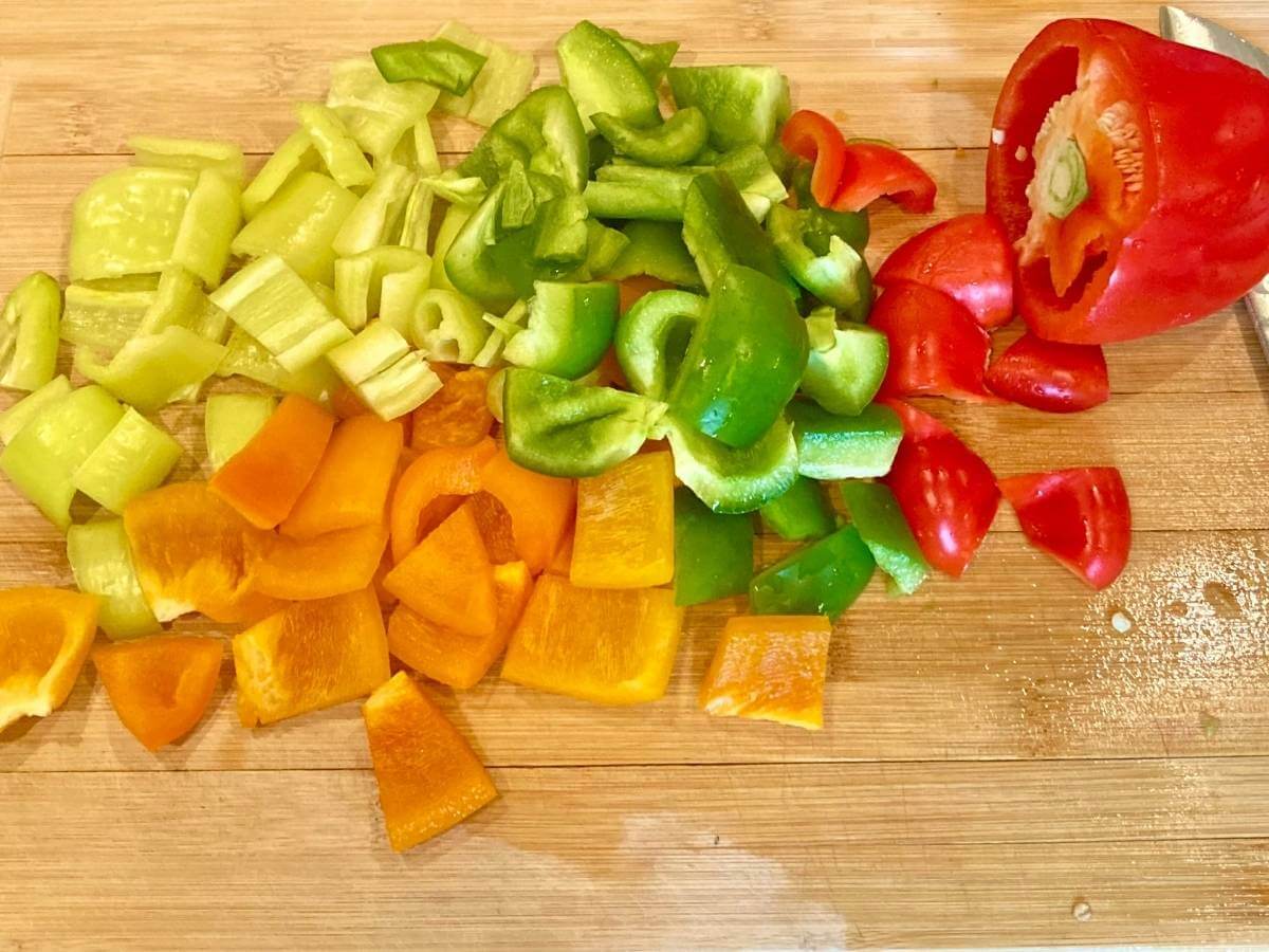Chopping peppers on a cutting board.