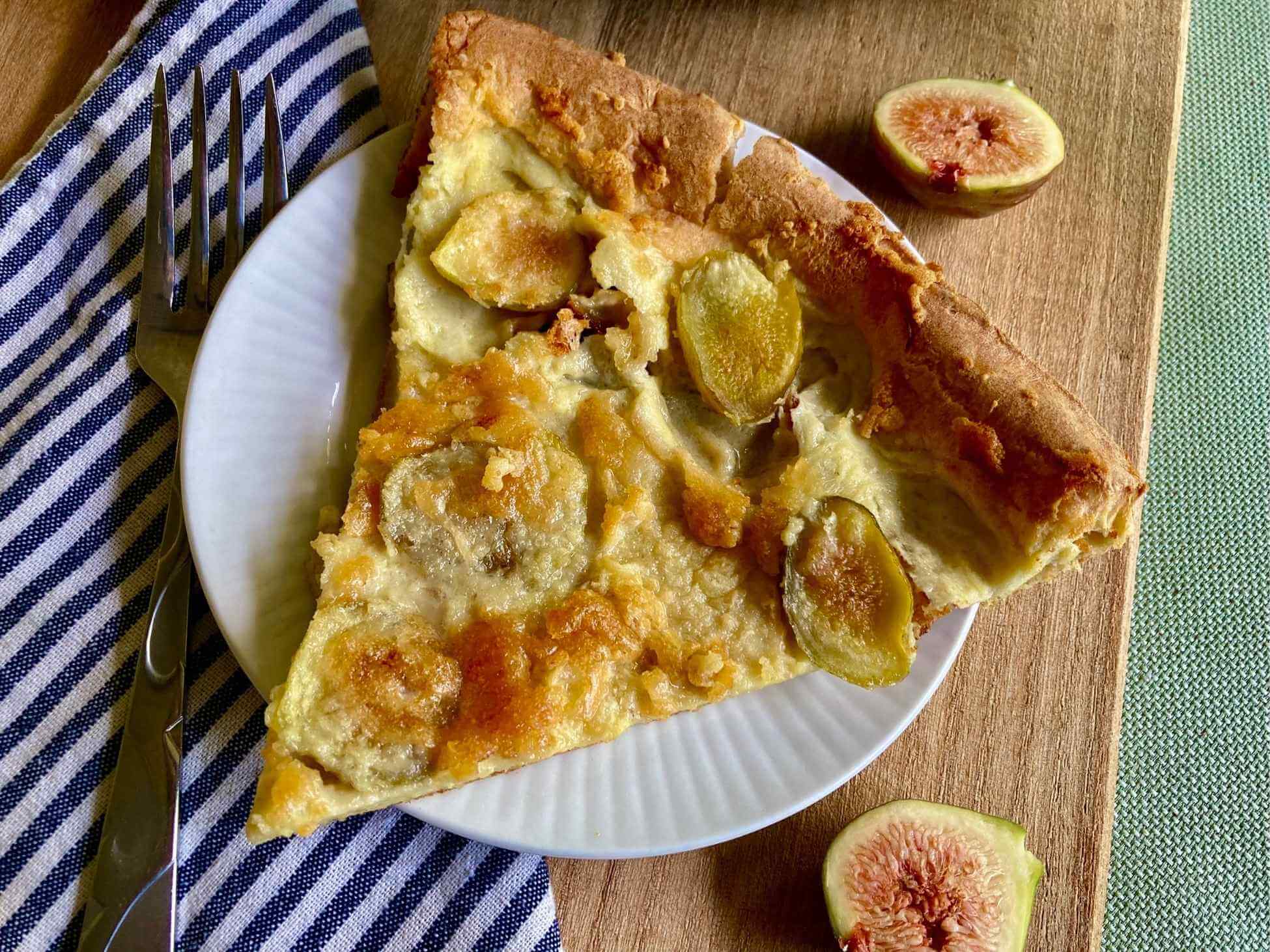 Slice of fig Dutch baby on a plate.