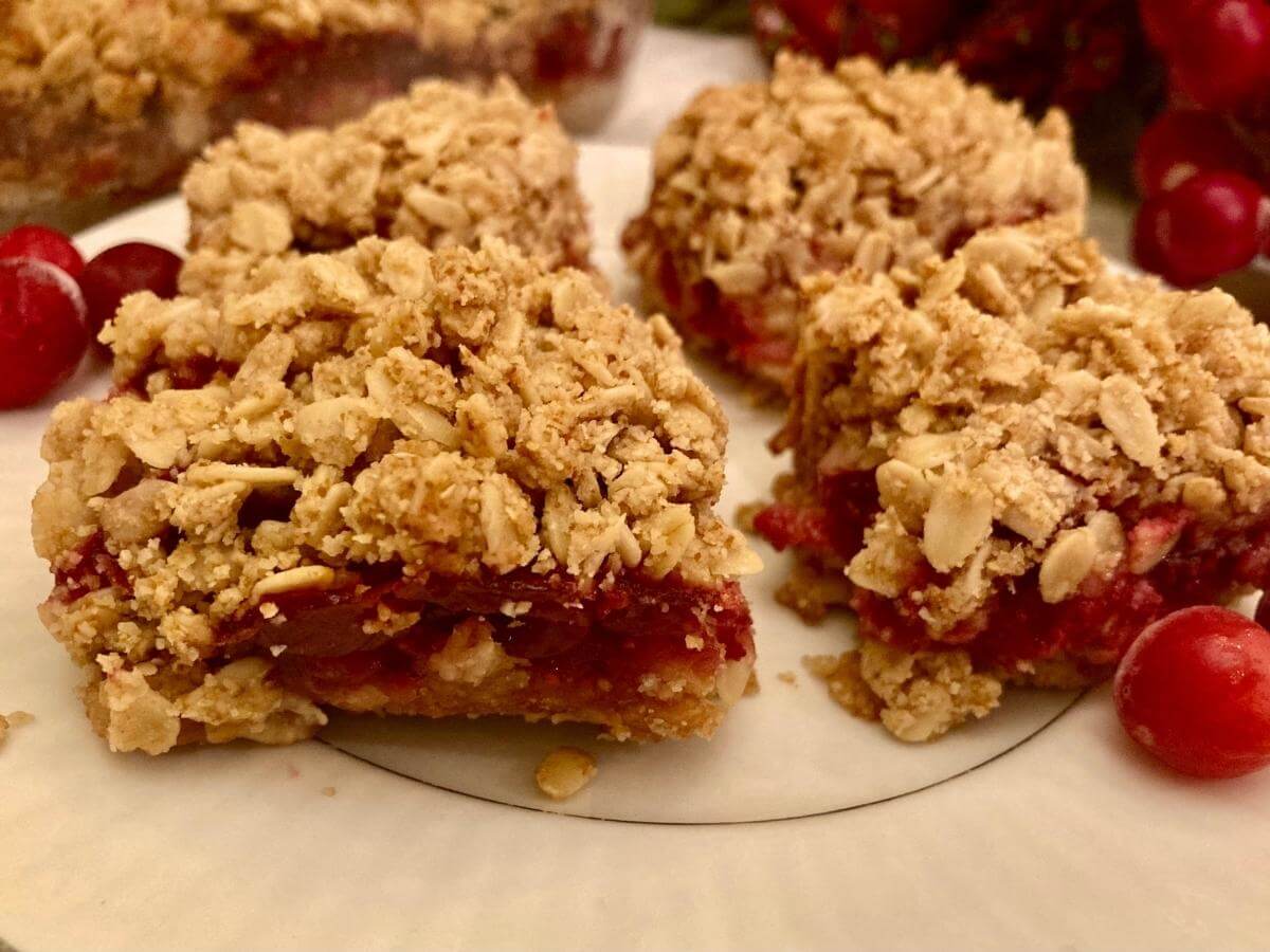 Closeup view of four gluten-free cranberry crisp bars.