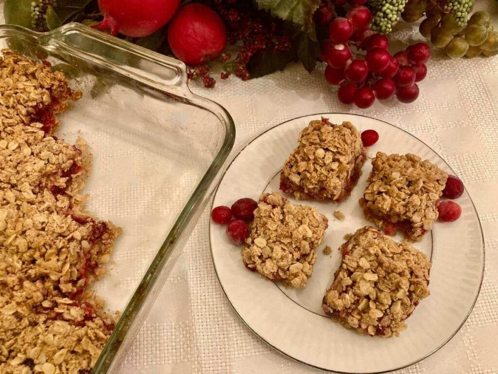 Gluten-free cranberry crisp bars being cut out of pan.