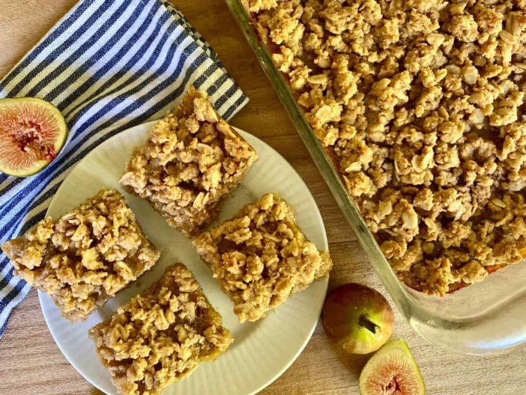 Gluten-free fig bars on a plate and uncut in a baking dish.
