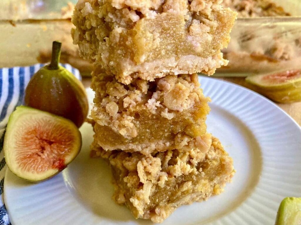 Stack of three gluten-free fig bars on a plate.