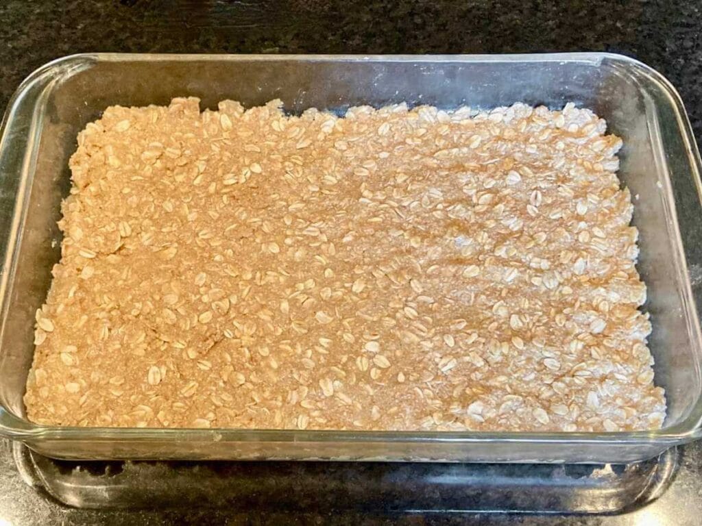 Oat crust in a baking dish.
