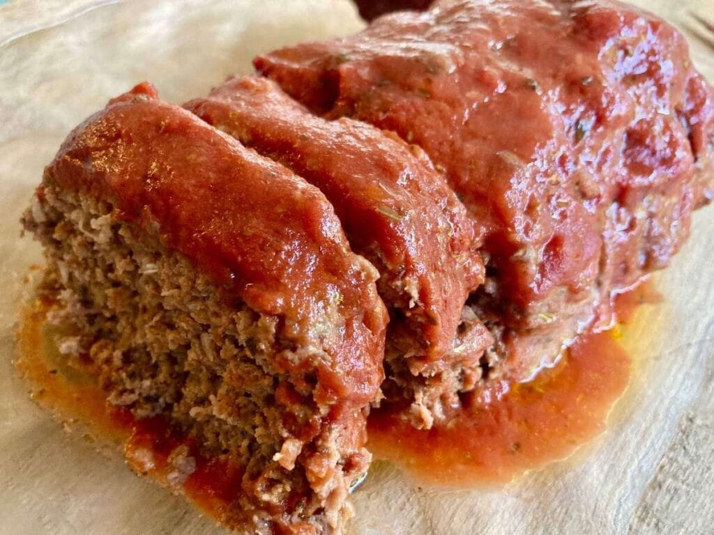 Loaf of sliced gluten-free meatloaf on a platter.
