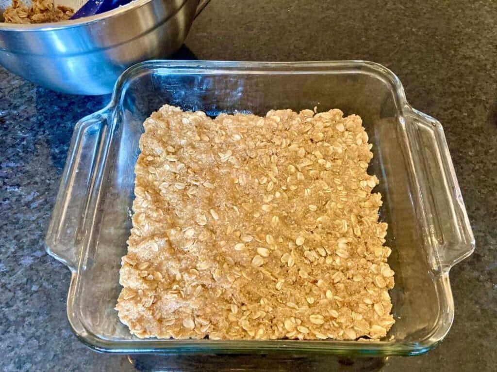 Oat crust in a glass baking dish.
