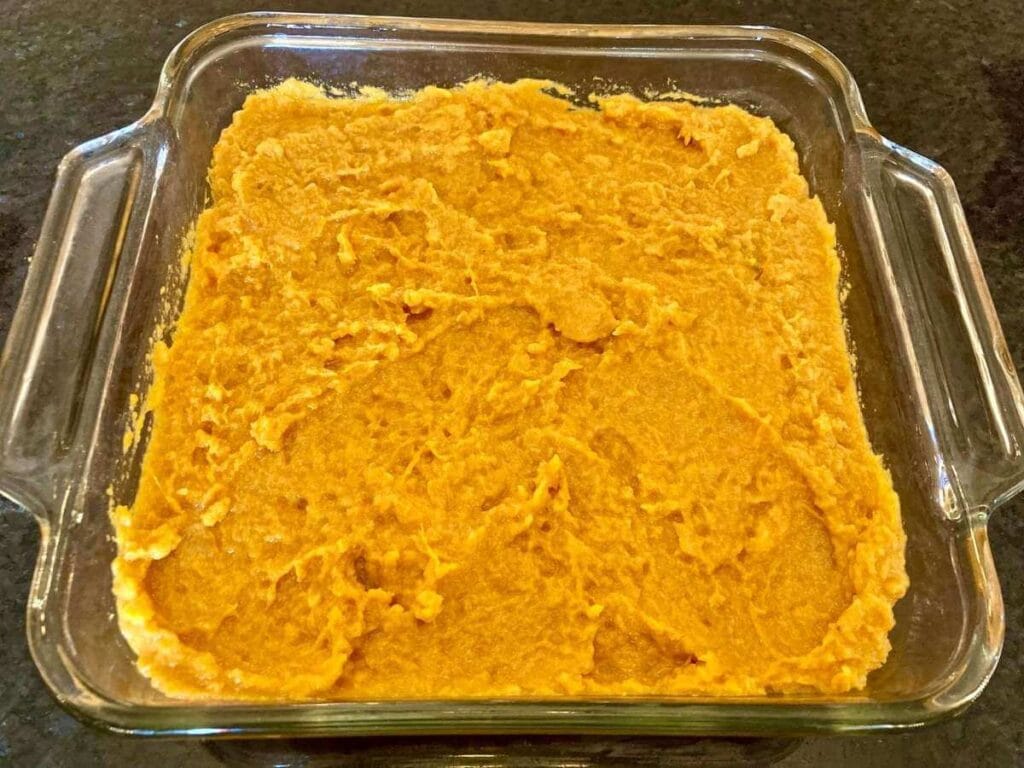 Sweet potato mixture in a glass baking dish.