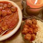 Gluten-free meatballs in a serving dish and a bowl with meatballs and cauliflower rice.