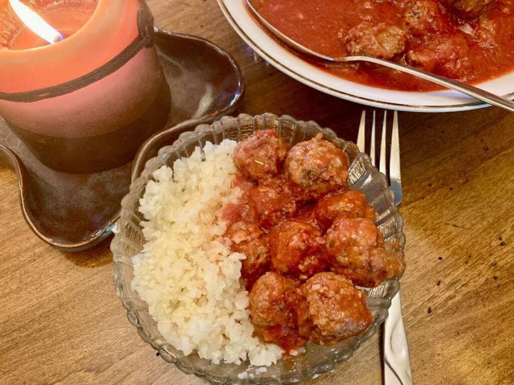 Gluten-free meatballs in a bowl with cauliflower rice.