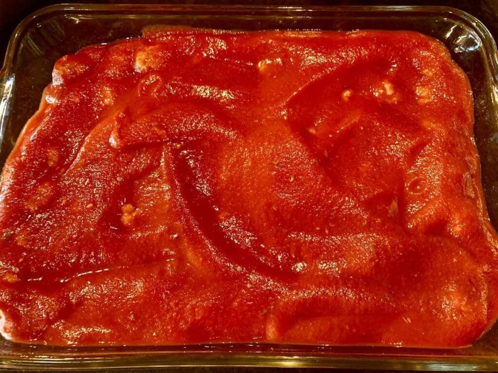 Meatballs in a baking dish before baking.